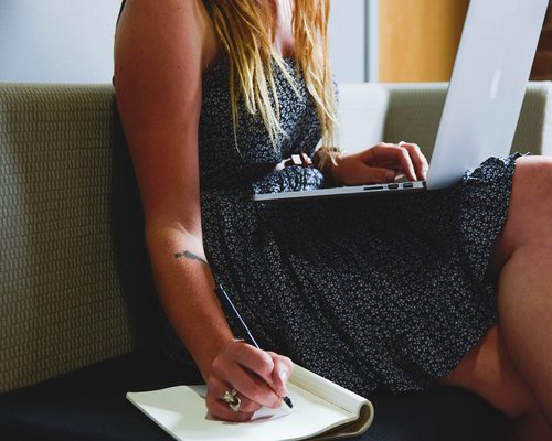 Indonesian professional working from home, adjusting sitting position on a comfortable chair