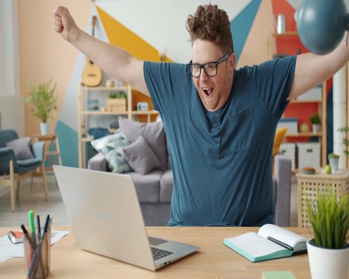Person stretching gently at home office desk with natural light